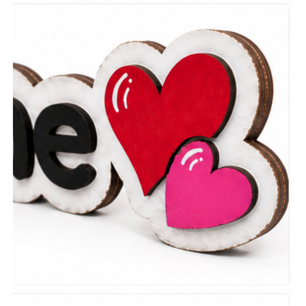 Close-up of the red and pink layered hearts on the Kiss Me wooden shelf sitter showing hand-painted details.